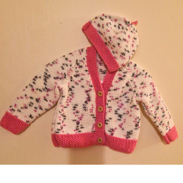Hand Knitted Baby Cardigan and hat in Pink and white.